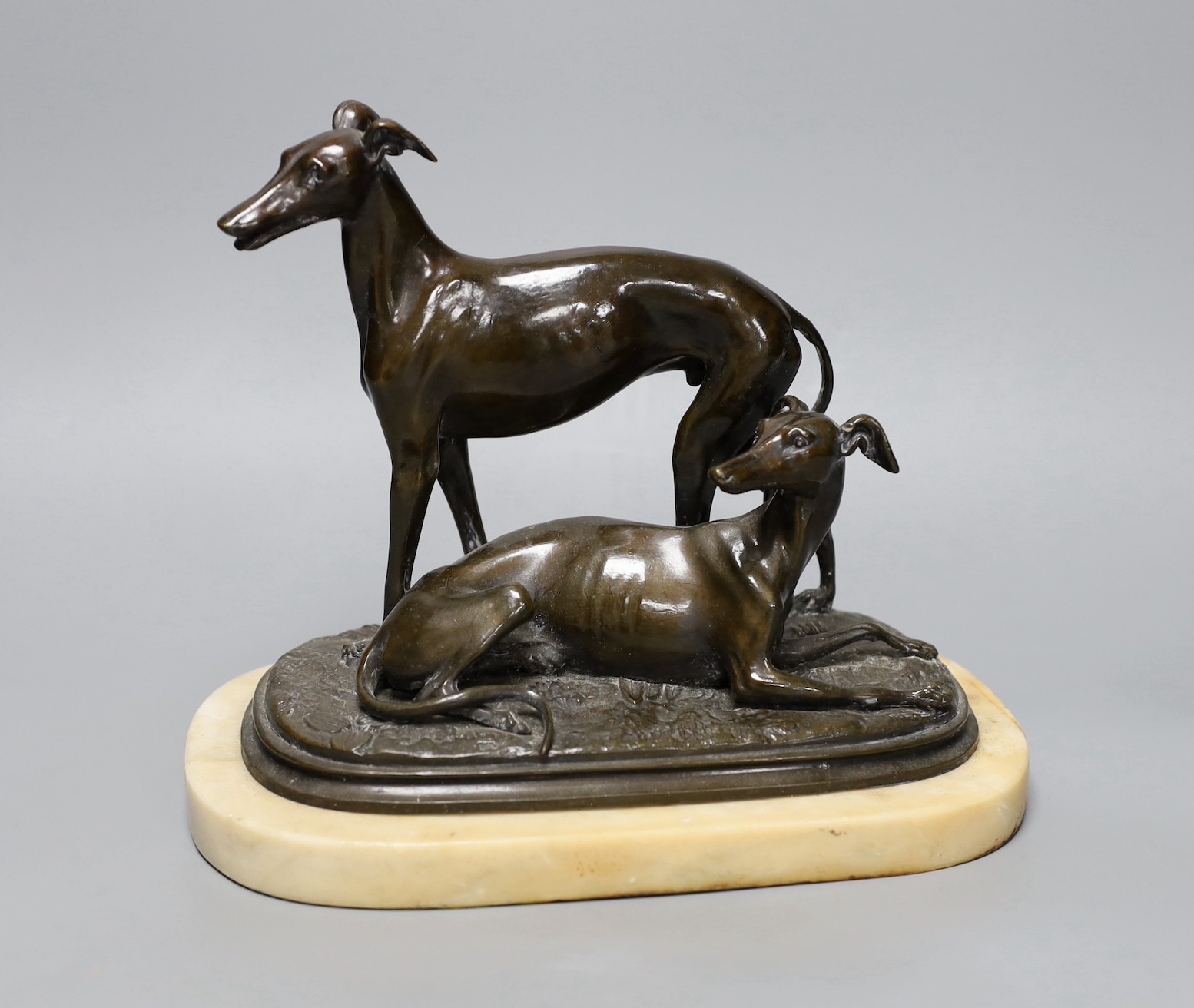 A 19th century patinated spelter greyhound group, unsigned, on alabaster plinth, 20cm high
